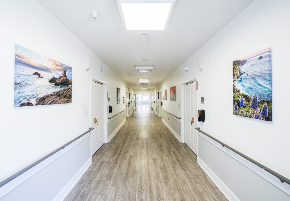 A modern and clean hospital hallway with artwork on the walls.