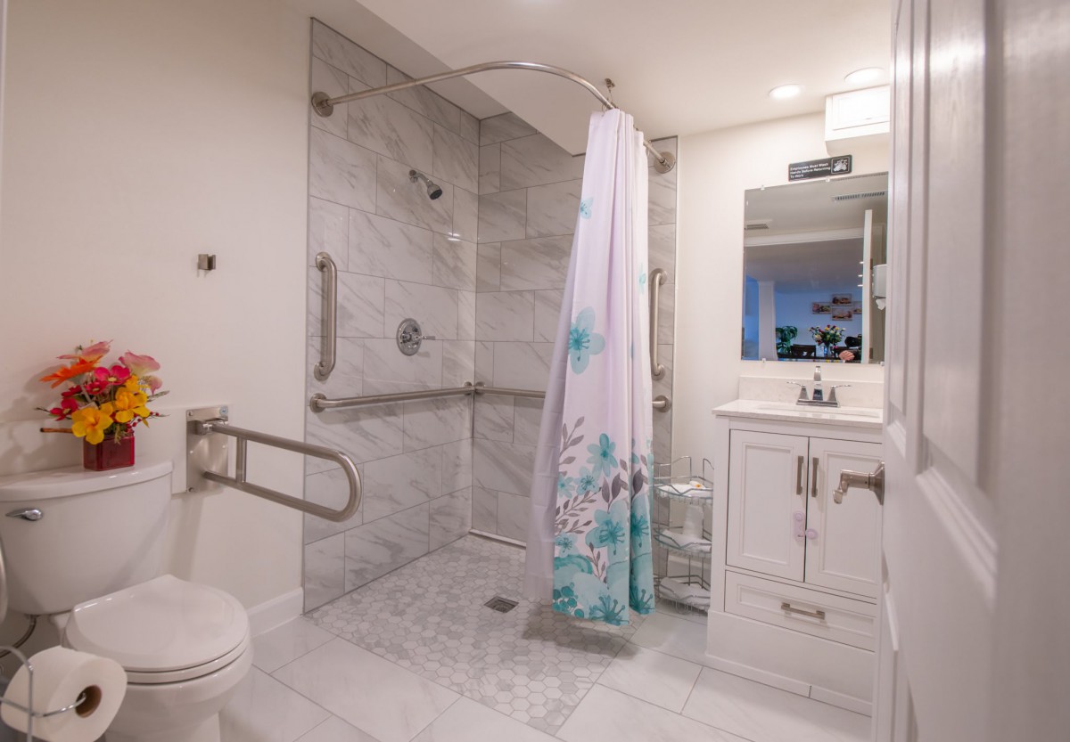 A modern bathroom with a walk-in shower and marble tile design.