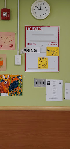 A vibrant display of wall decorations showcasing children's artwork, seasonal themes, and cheerful messages.