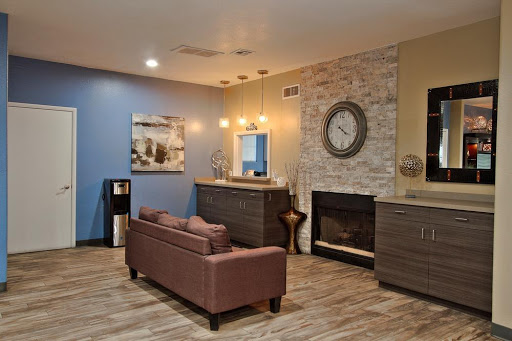 A stylish living room featuring modern furniture, a cozy fireplace, and artistic wall decor.