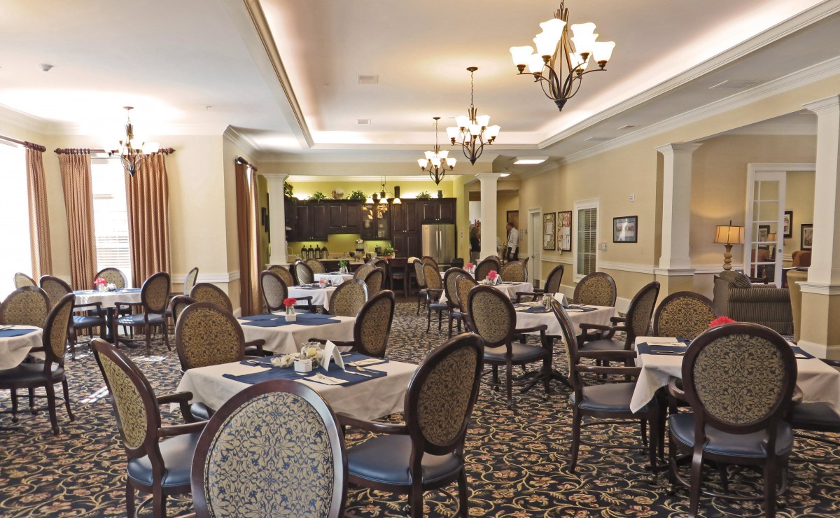 Elegant dining room with classic chandeliers and neatly arranged tables.