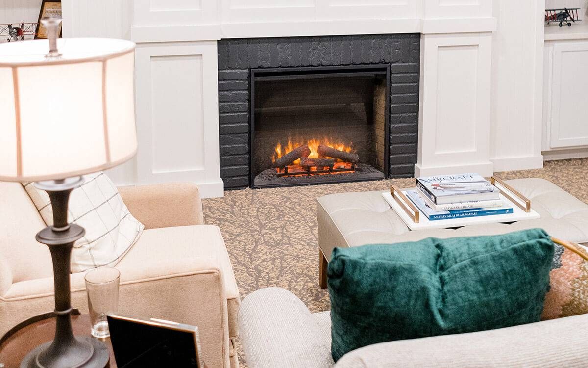 A cozy living room with a modern fireplace and comfortable seating.