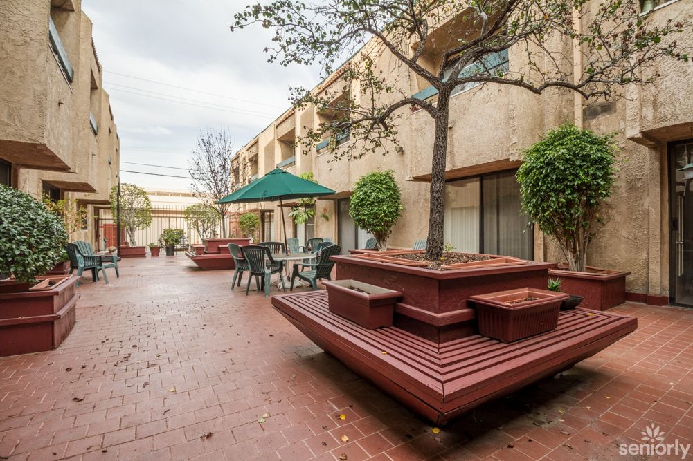 A pleasant courtyard with outdoor seating and greenery.