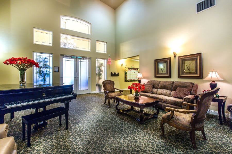 Elegant lobby with a grand piano and comfortable seating arrangement.
