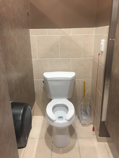 A clean restroom featuring a standard toilet and tiled walls.