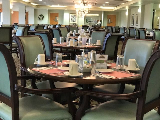 A well-arranged dining area with multiple tables set for guests.