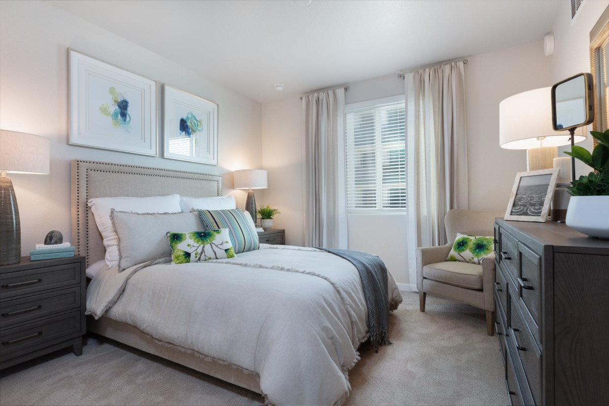 A modern and cozy bedroom with elegant decor and comfortable bedding.