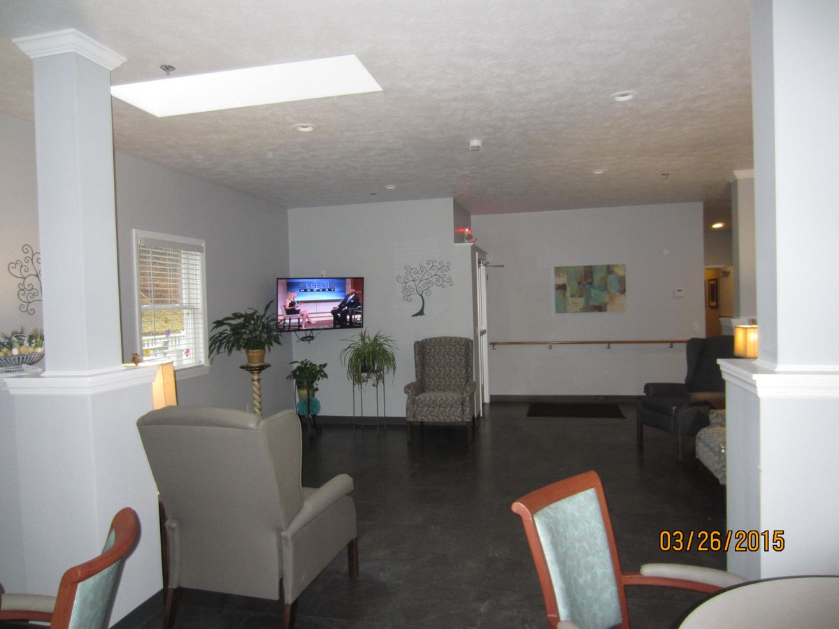 A modern lounge area with comfortable seating and a television.