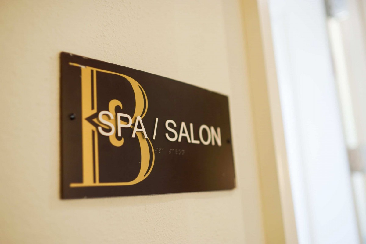 Sign indicating the location of a spa and salon.