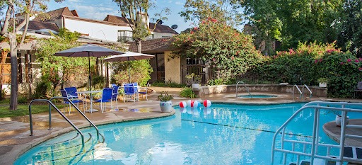 A serene residential pool area, perfect for relaxation on a sunny day.