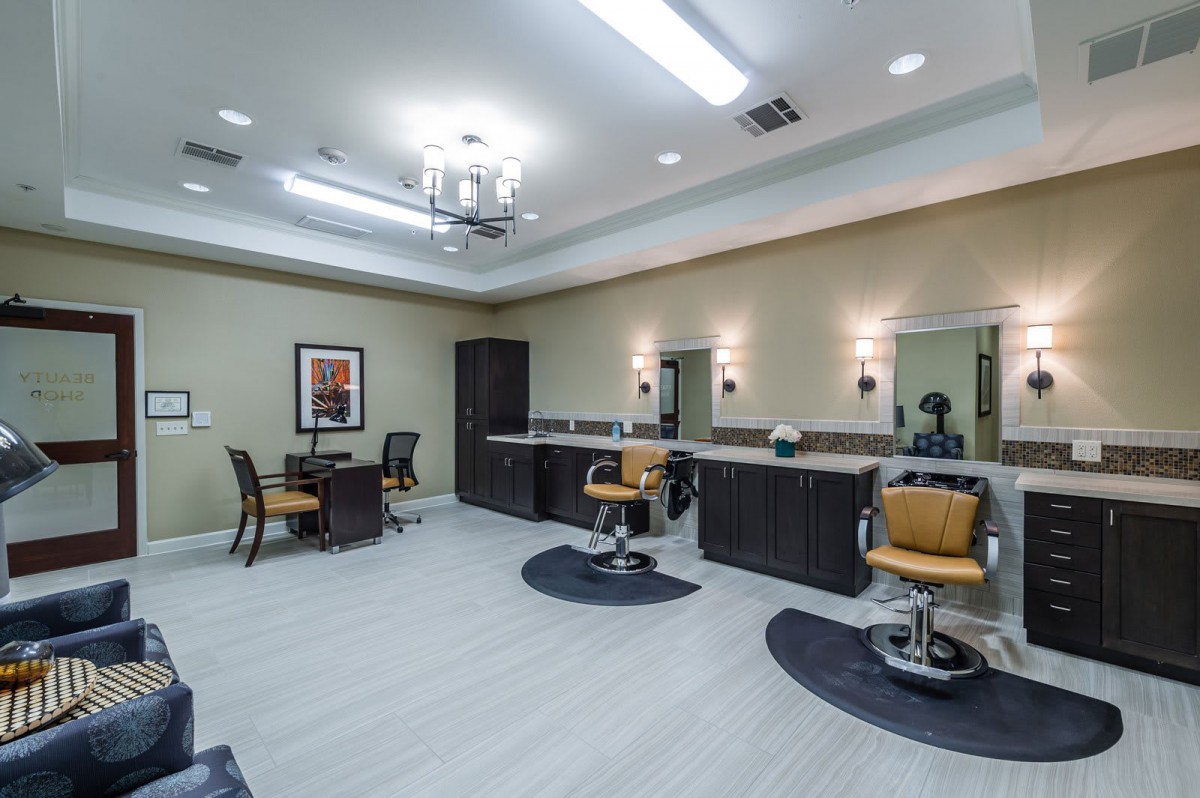 A modern hair salon interior with styling chairs, mirrors, and elegant lighting.