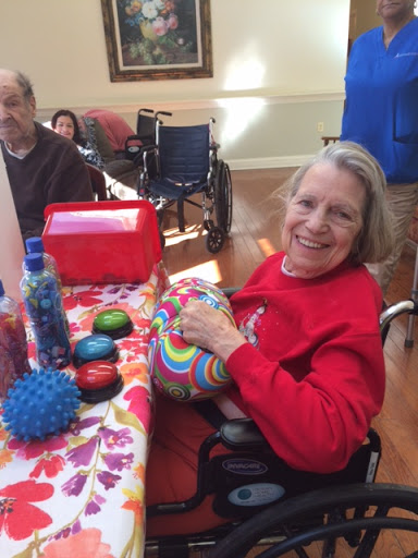 A joyful moment of creativity as a senior engages in a colorful craft activity.