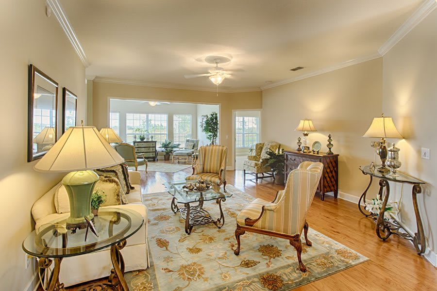 A traditional living room with elegant furniture and warm lighting.