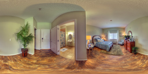 A cozy and inviting bedroom space with wooden flooring and soft lighting.