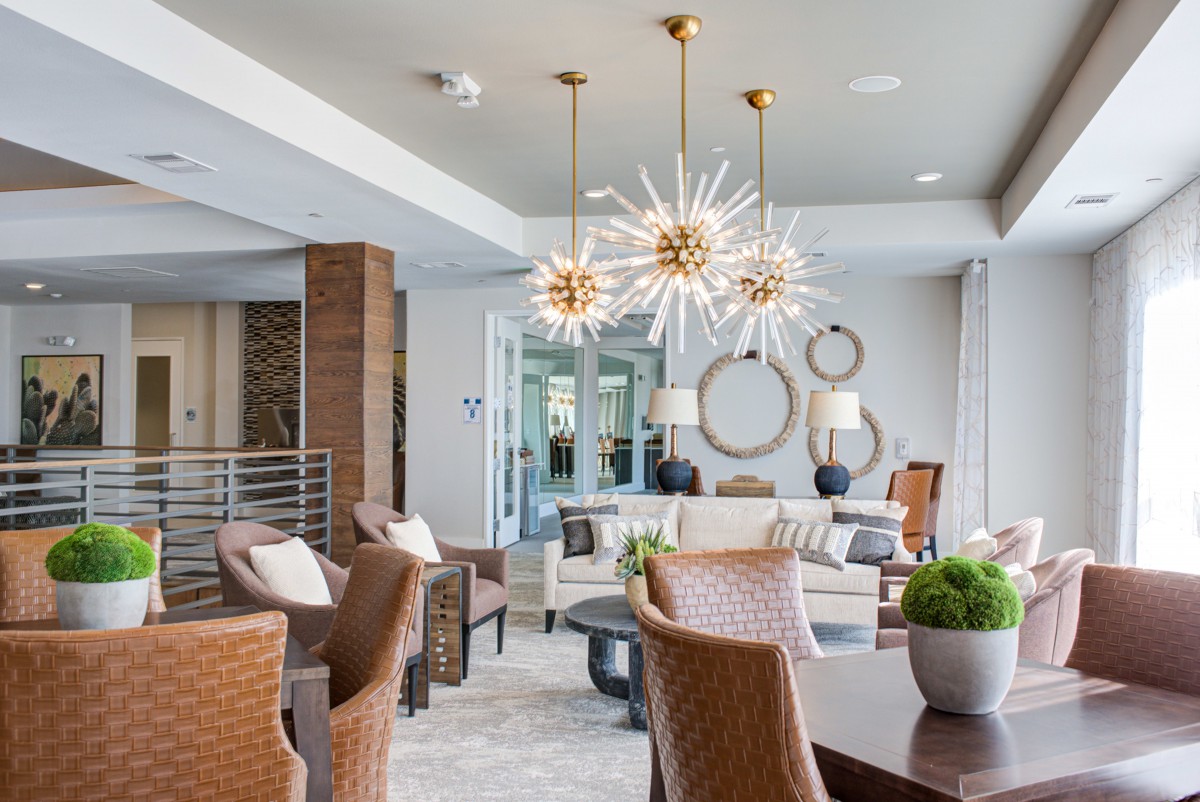 A modern and stylish living room featuring contemporary chandeliers and elegant furniture.