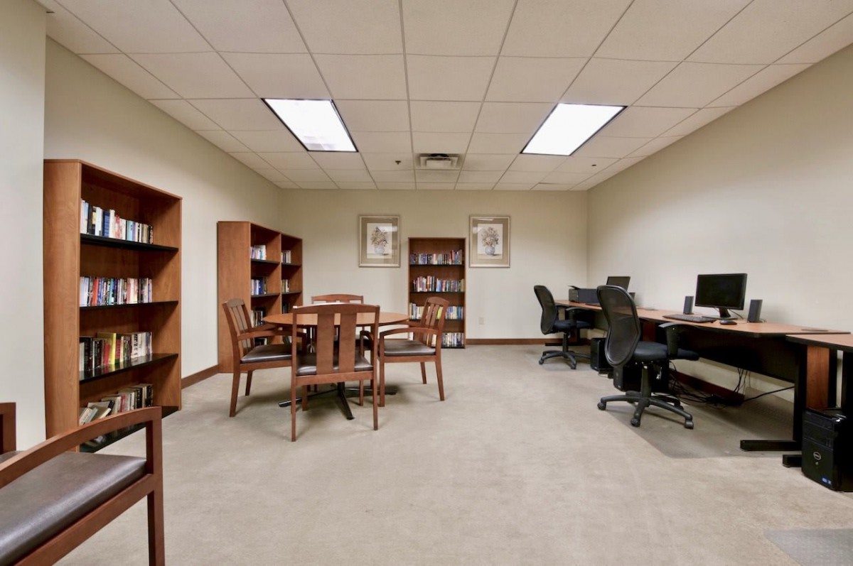 A quiet study room with bookshelves and computer workstations.
