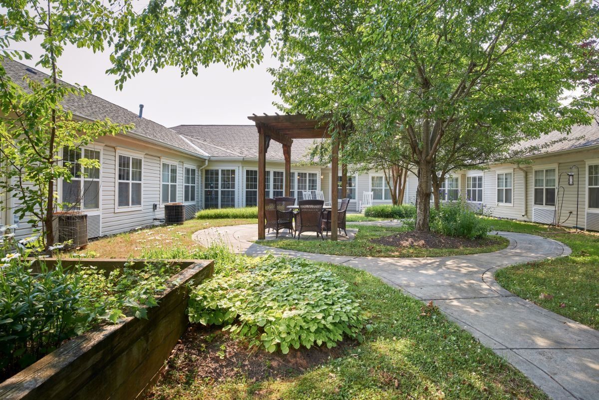 A peaceful courtyard with a gazebo and lush greenery.