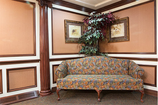A colorful couch in a well-decorated corner of a living space.