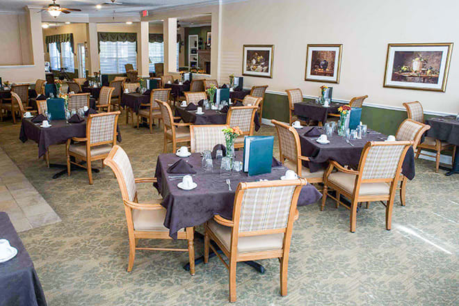An elegant dining area with neatly arranged tables and chairs, ready for guests.