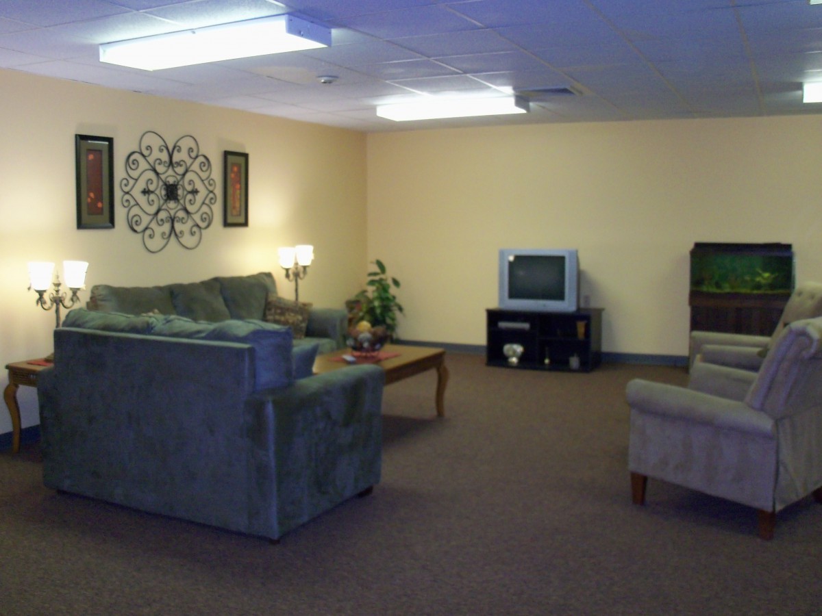 A cozy living room with sofas, a TV, and a coffee table.