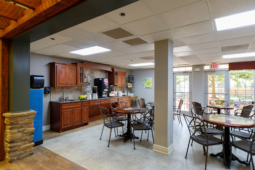 A cozy kitchen and dining area with wooden cabinets and a casual seating arrangement.