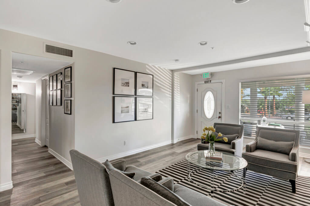 A modern and minimalist living room featuring sleek furniture and contemporary decor.