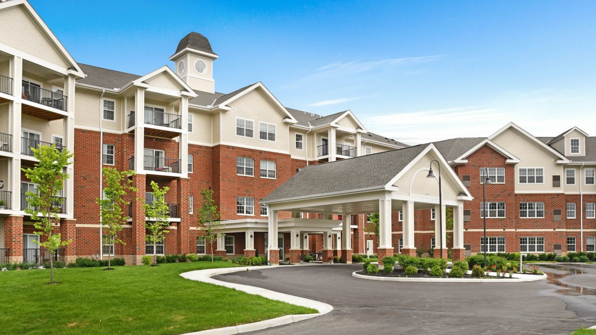A modern residential apartment complex with a welcoming entrance and well-maintained landscaping.
