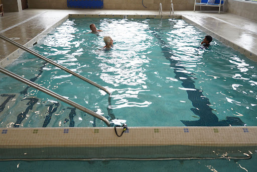 Participants enjoying a session in an indoor swimming pool.