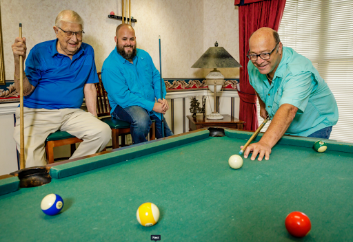 A group of friends enjoying a game of pool together.