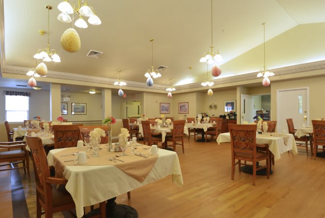 A cozy restaurant dining area with neatly arranged tables and warm lighting.