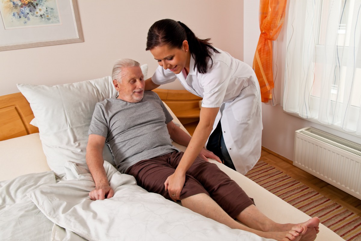 A nurse assisting an elderly patient in a healthcare setting.