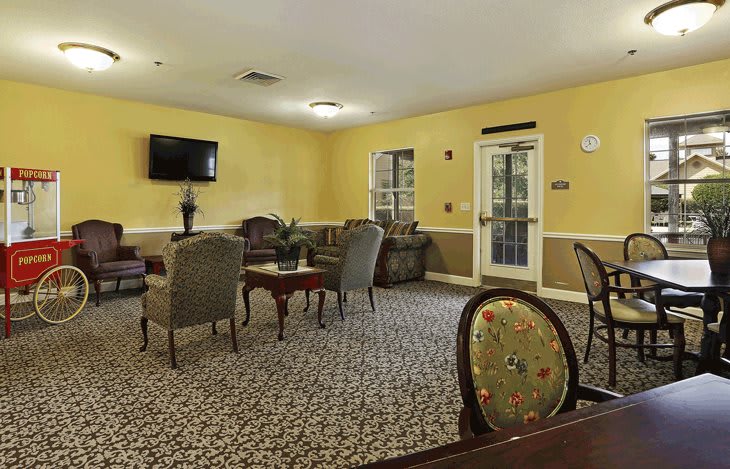 A cozy living room with comfortable seating and a mounted television.