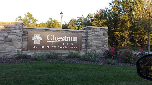 Entrance sign for Chestnut Fields Retirement Community, surrounded by well-maintained landscaping.