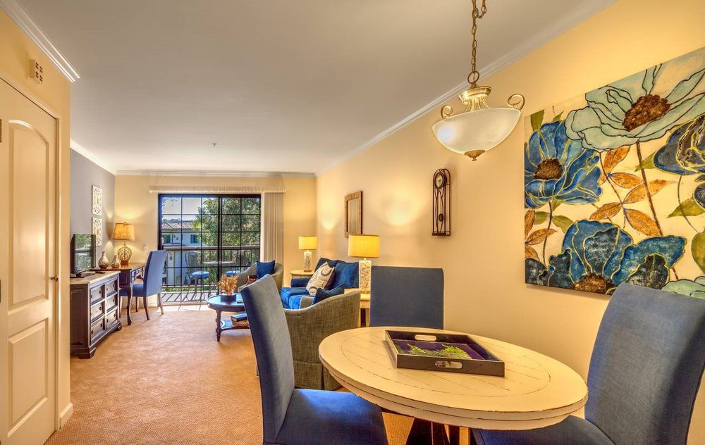 A modern living and dining area with stylish furnishings and bright lighting.