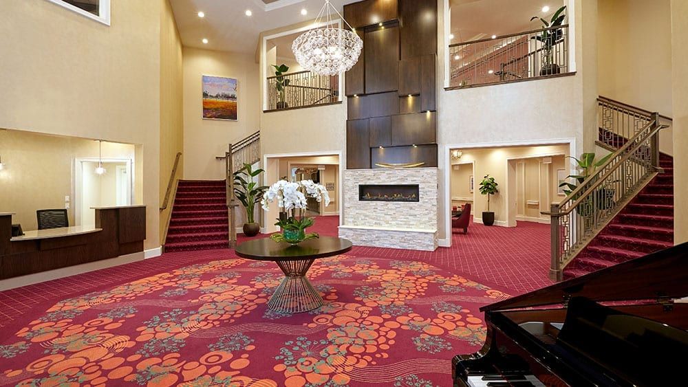 Elegant hotel lobby with a grand staircase and modern decor.