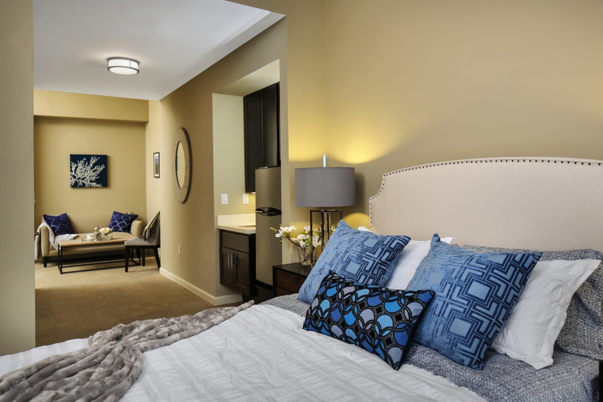 A modern and comfortable bedroom with stylish decor and cozy bedding.