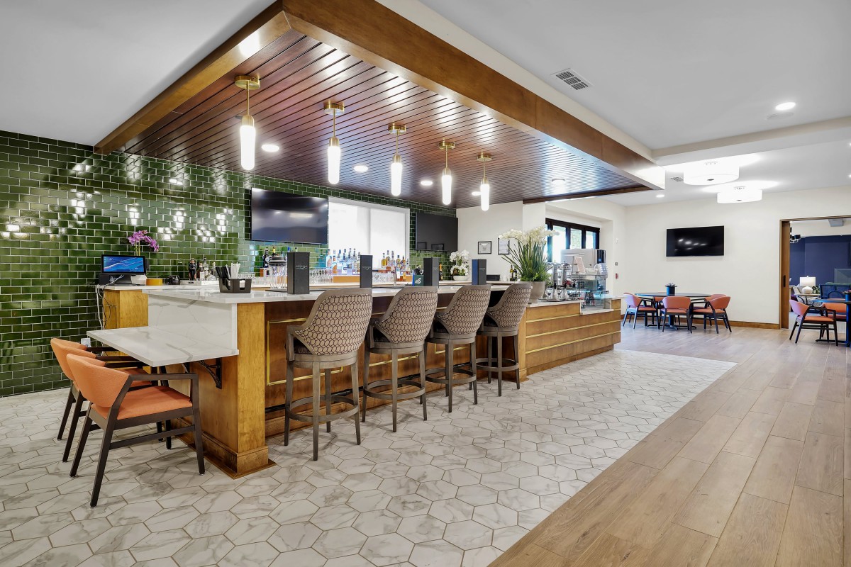 A modern bar area with stylish seating and lighting.