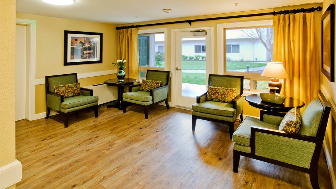 A cozy waiting room with comfortable seating and large windows.