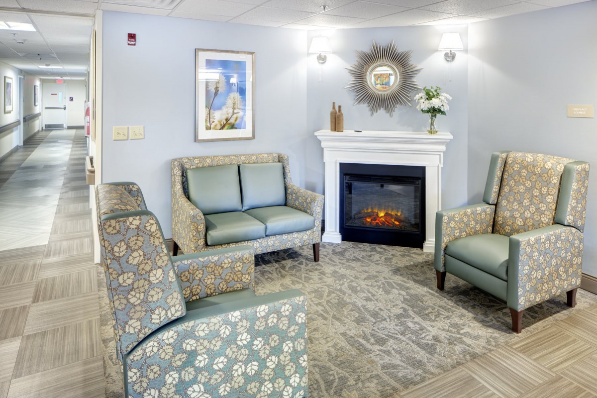 A cozy living room with comfortable seating, a decorative fireplace, and tasteful decor.