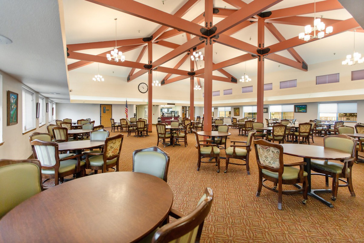 Spacious dining hall with elegant wooden beams and comfortable seating.
