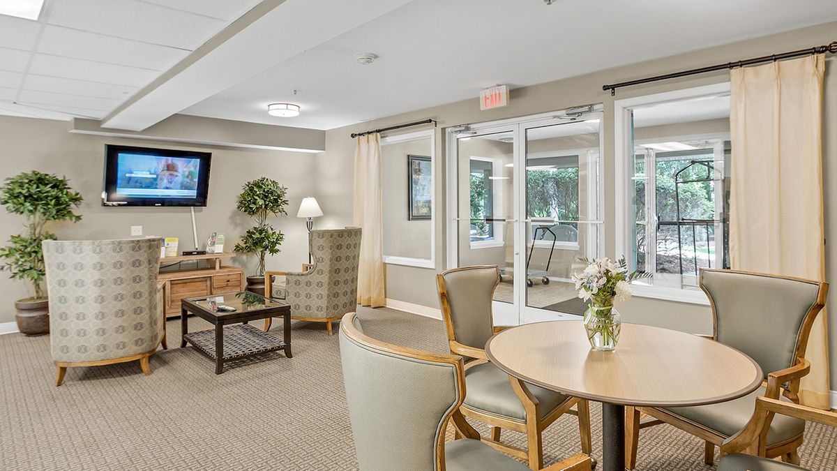 A cozy and well-lit living room with comfortable seating and a television.