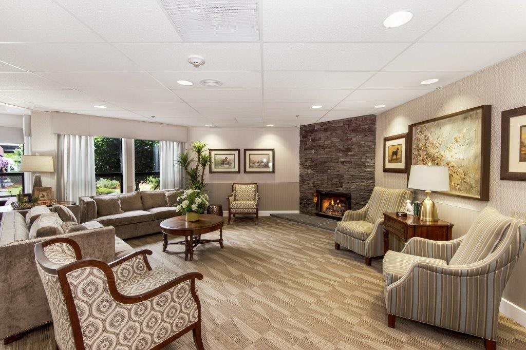 A cozy living room with a fireplace, comfortable seating, and elegant decor.