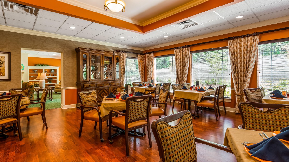 A cozy dining area with elegant furnishings and large windows.