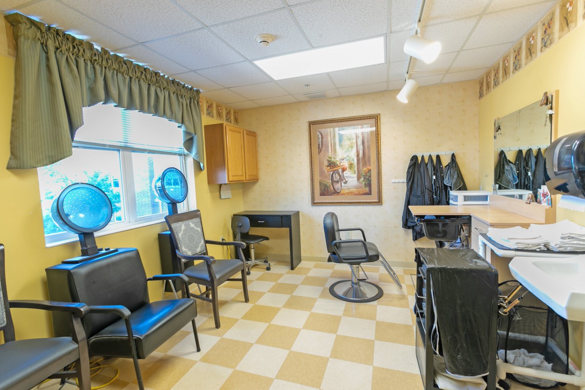 A cozy hair salon interior with chairs and mirrors.