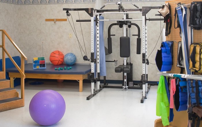 A gym setup with various fitness and exercise machines.