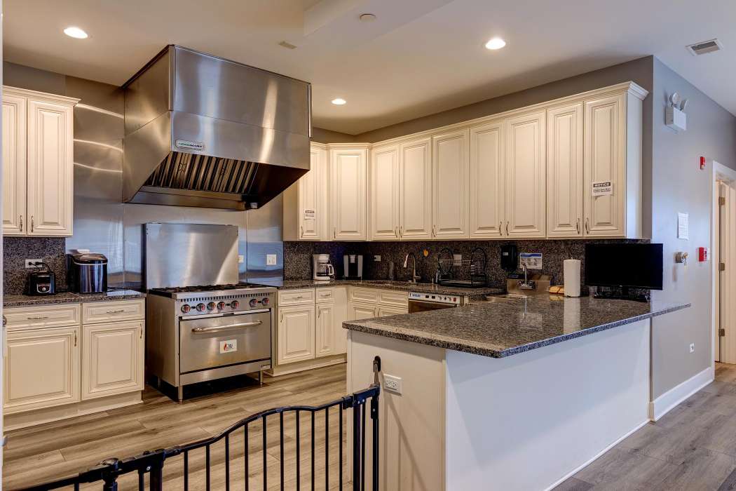 A modern kitchen with stainless steel appliances and wooden cabinets.