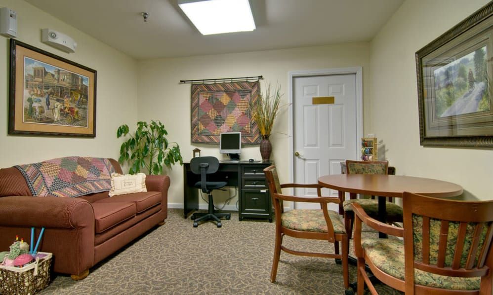 A cozy office space with a sofa, computer desk, and decorative elements.