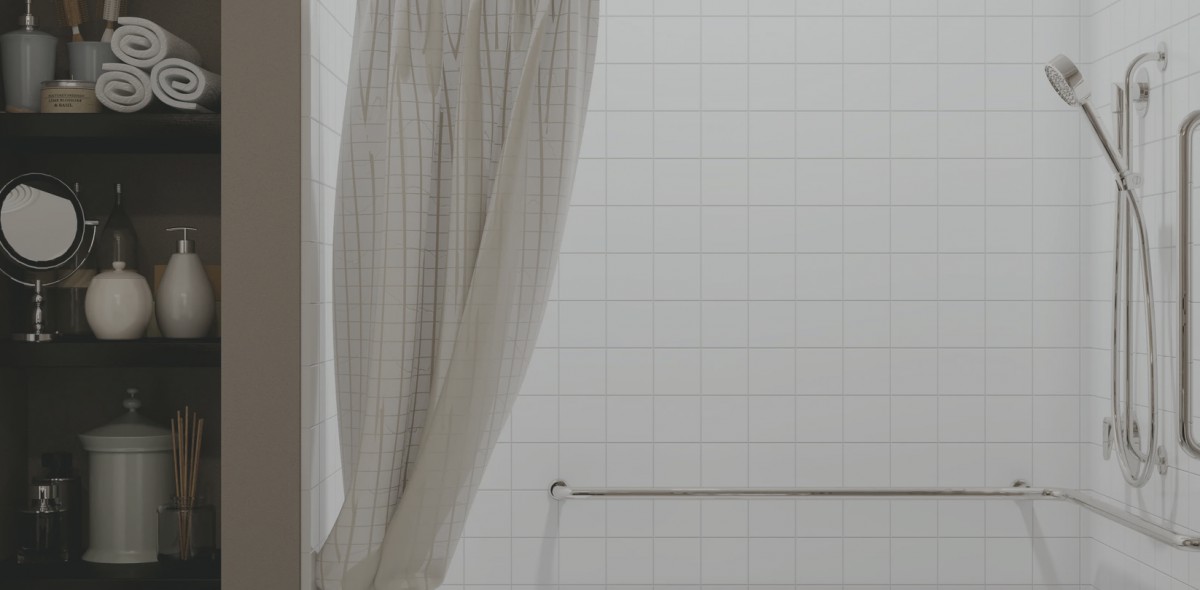 A bathroom with a light-colored curtain and towel rack against a tiled wall.