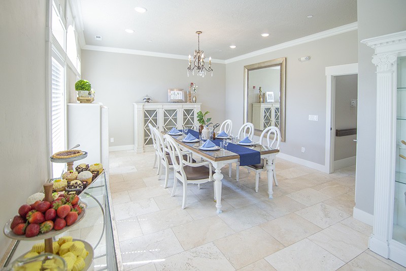 A beautifully decorated dining room with elegant furnishings and a chandelier.