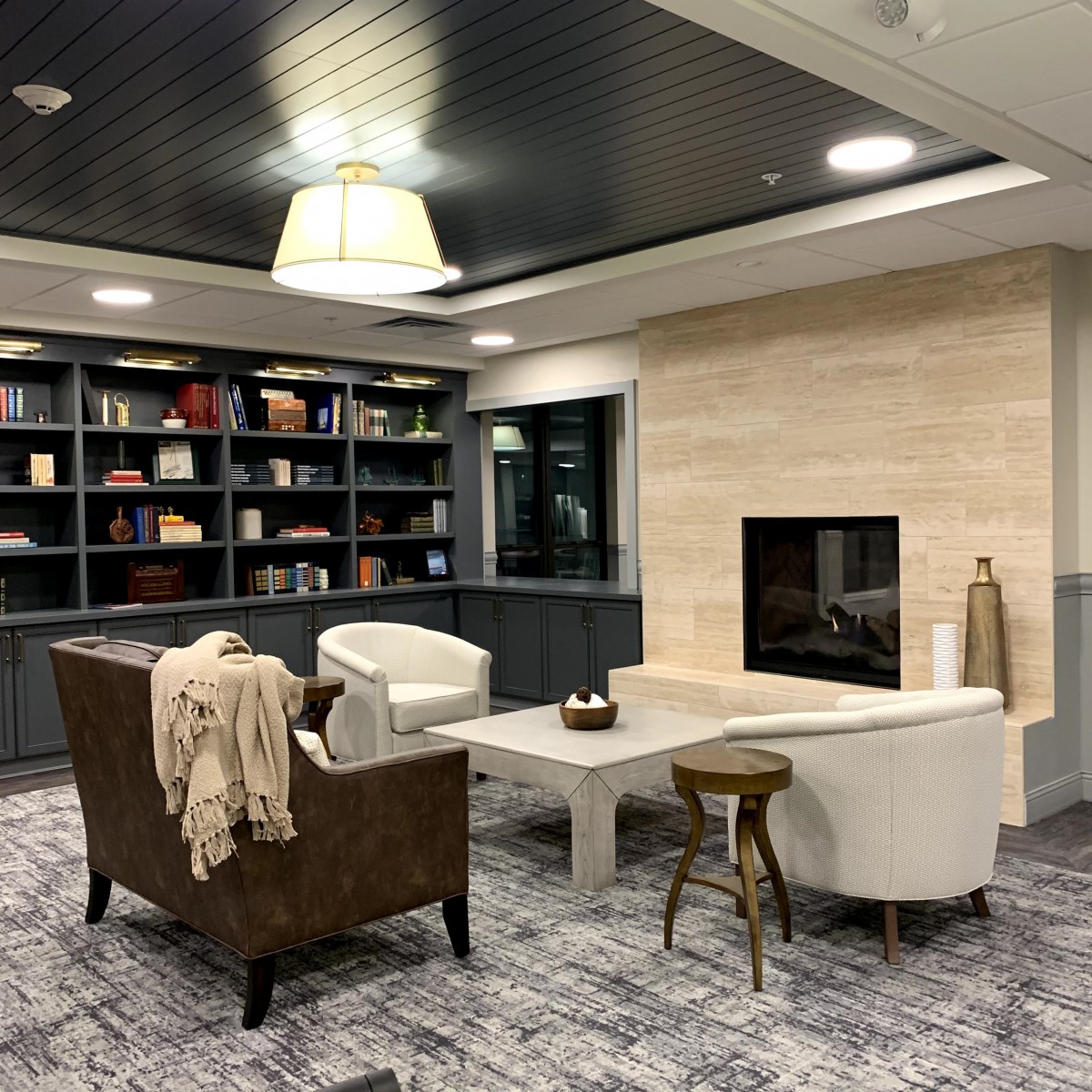 A modern living room with a cozy seating area and fireplace.